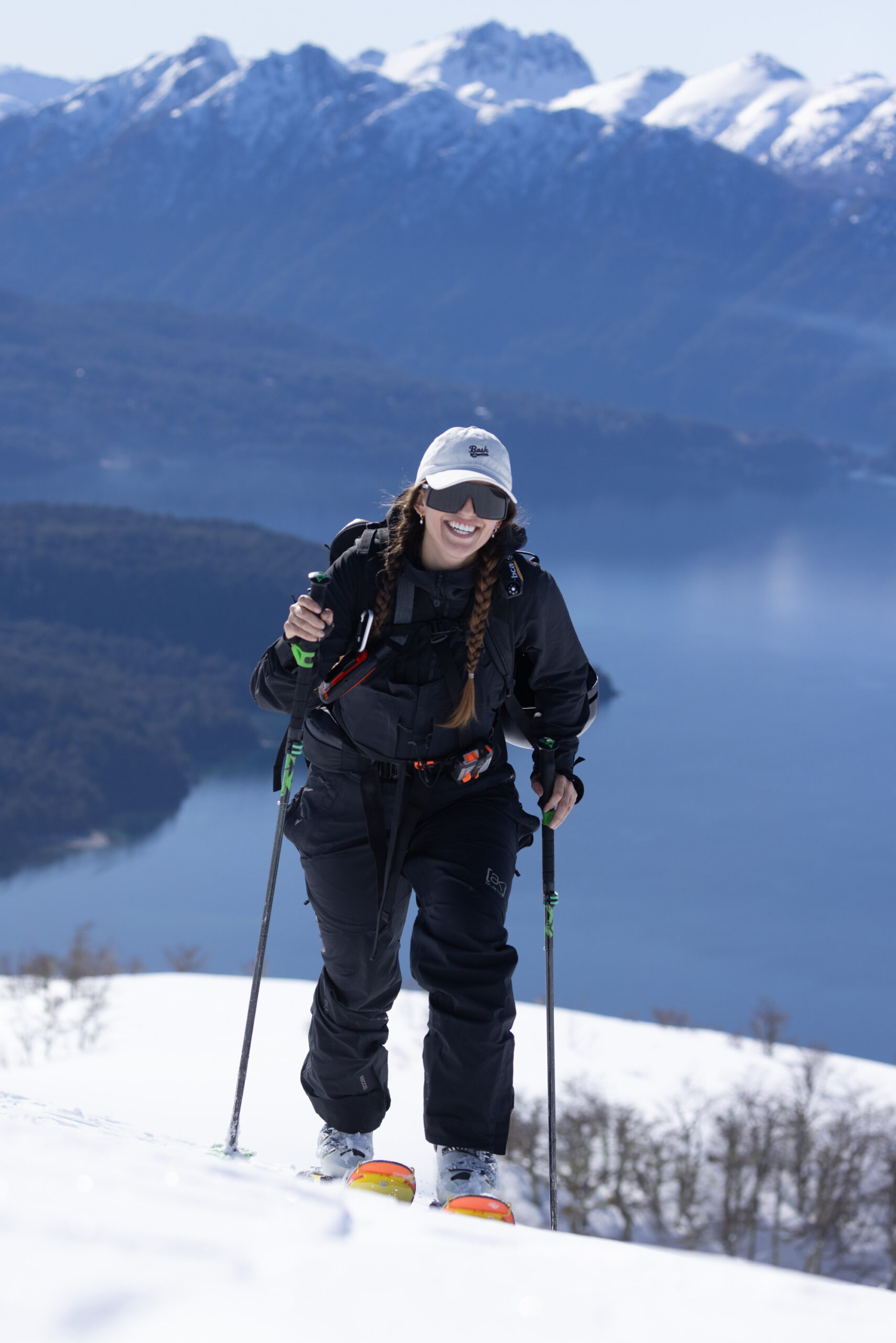Female splitboarder hiking through snow-covered Andes during LUX Snow retreat in Patagonia