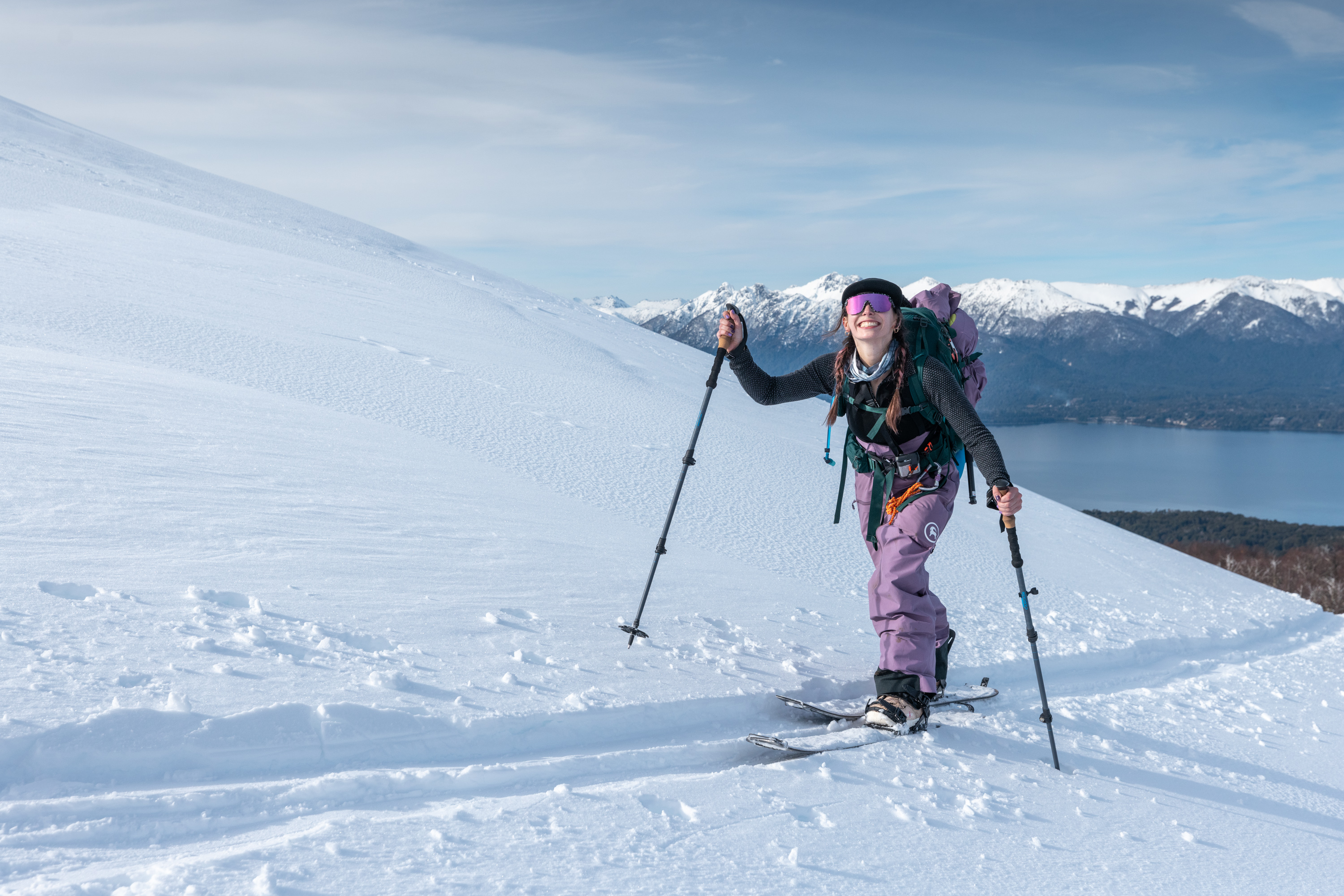 Female splitboarder hiking through snow-covered Andes during LUX Snow retreat in Patagonia