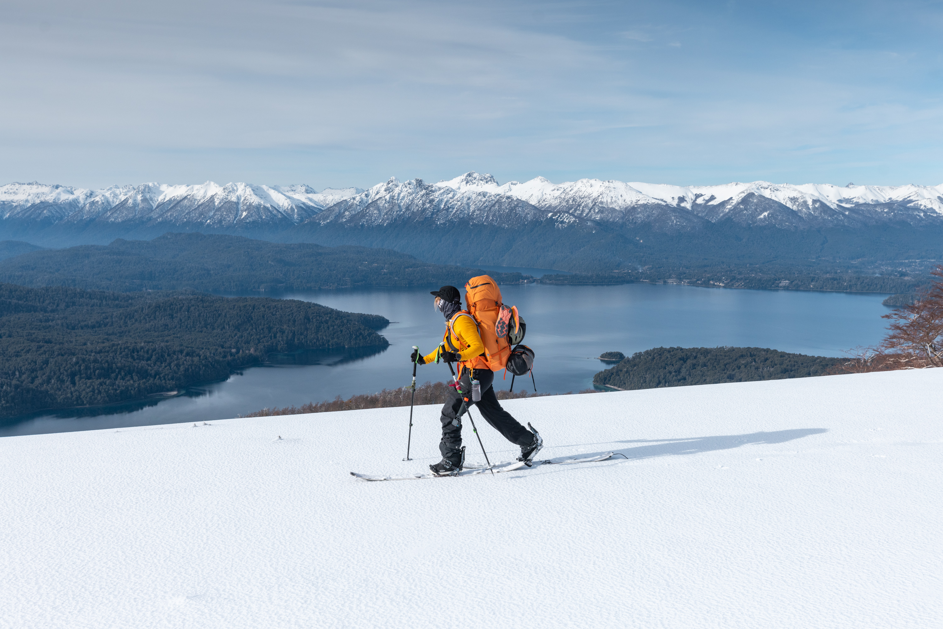 Female splitboarder hiking through snow-covered Andes during LUX Snow retreat in Patagonia