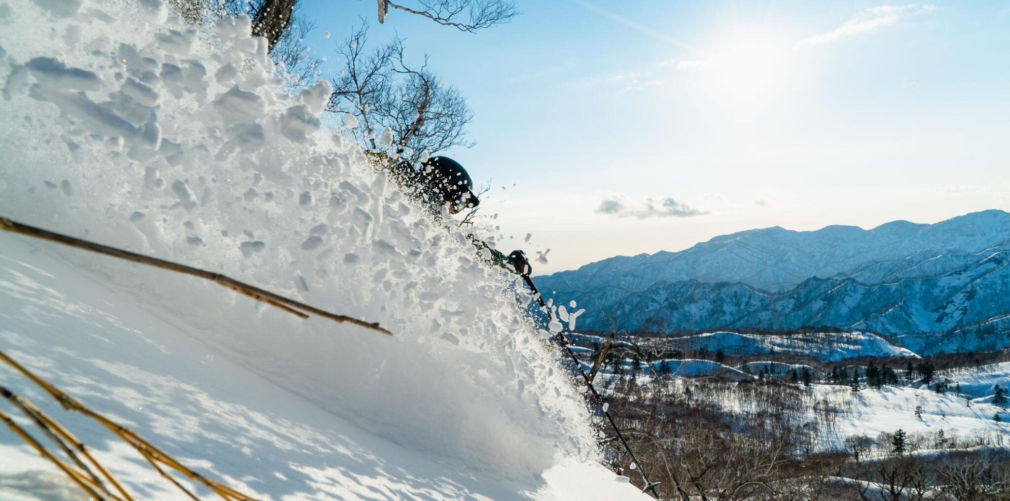 a women carving a powder turn during her lux snow all women backcountry retreat